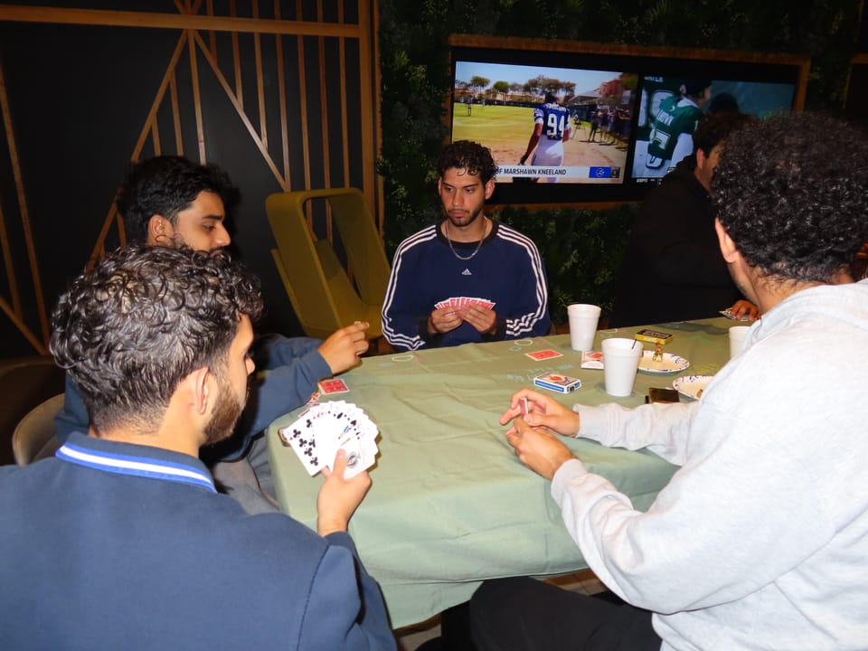 ASA members around a table mid-card-game at game night