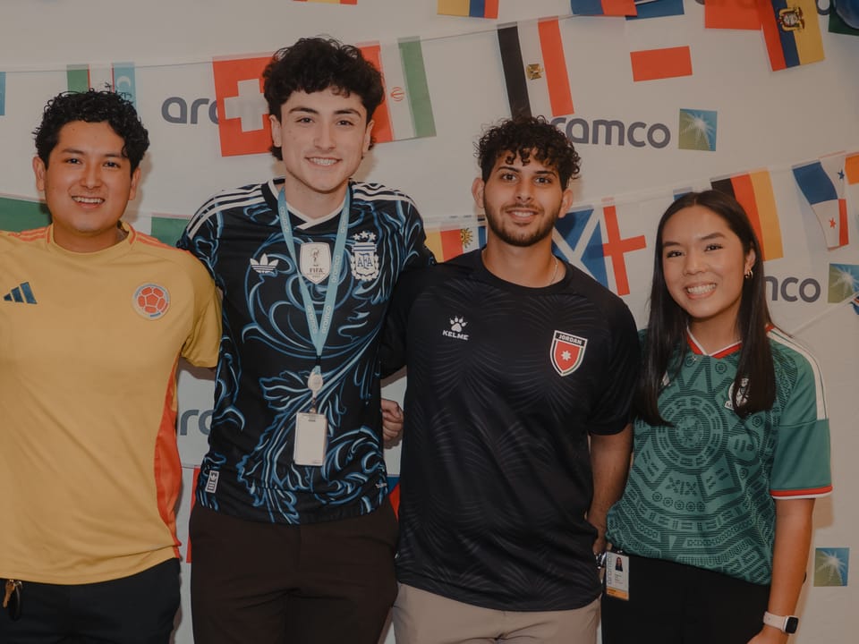 Aramco interns in national-team soccer jerseys at flag day, Faris in a Jordan kit